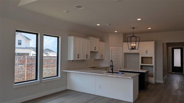438 Silver Moon Way, Katy, TX 77493 - kitchen featuring a peninsula, wood finished floors, white cabinets, black electric cooktop, and recessed lighting