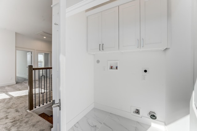 clothes washing area featuring cabinet space, hookup for a washing machine, baseboards, and electric dryer hookup