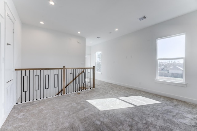 empty room featuring baseboards, carpet, visible vents, and recessed lighting