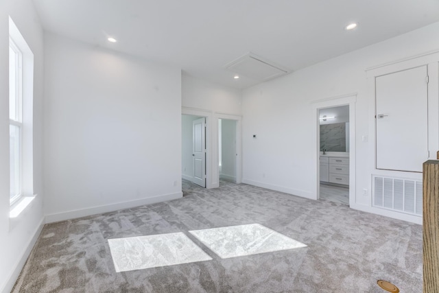 unfurnished bedroom featuring light carpet, recessed lighting, visible vents, and baseboards