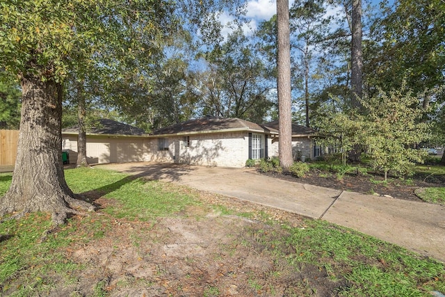 ranch-style home featuring fence