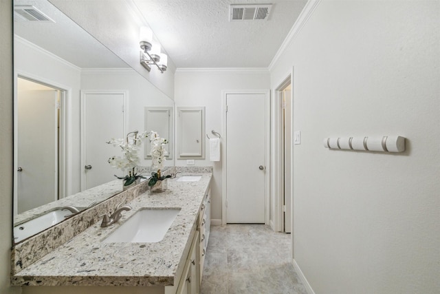 full bath with crown molding, visible vents, and a sink