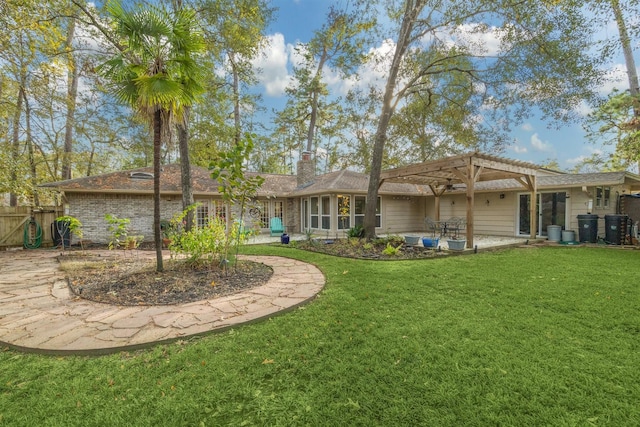 rear view of house with brick siding, a yard, a chimney, a patio, and a pergola