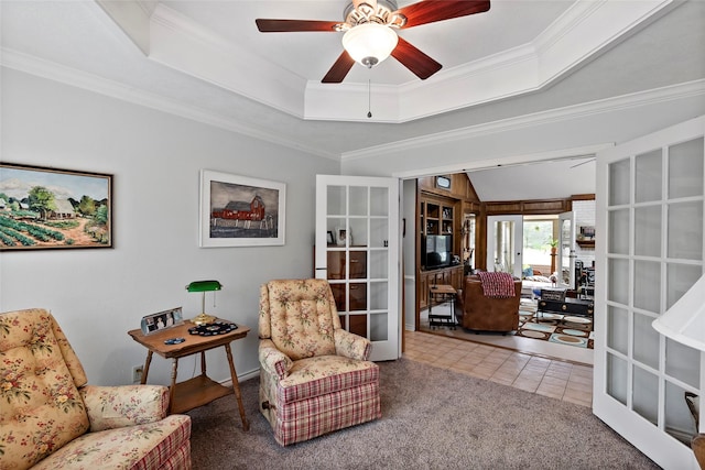 sitting room featuring french doors, a raised ceiling, crown molding, and tile patterned floors