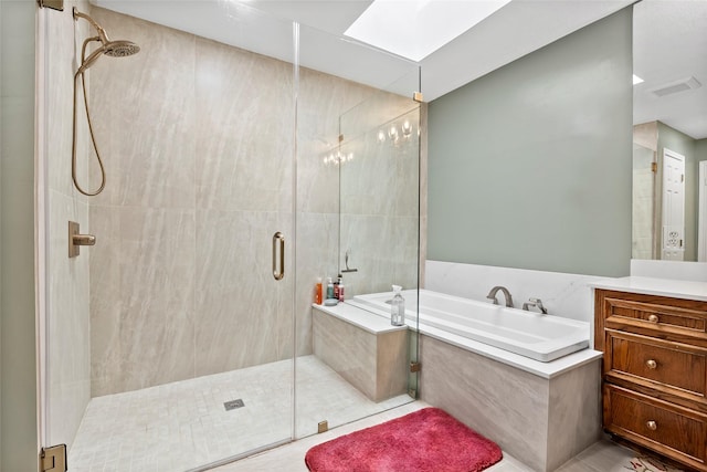 bathroom featuring a garden tub, a skylight, visible vents, vanity, and a stall shower