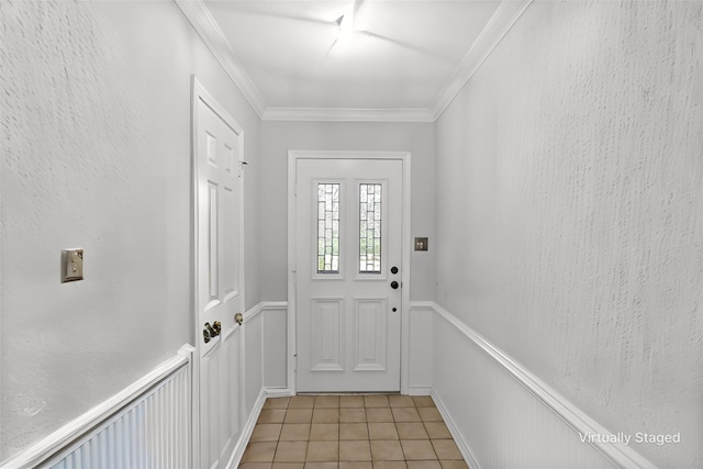 doorway featuring a textured wall, wainscoting, crown molding, and light tile patterned floors