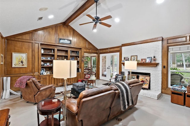 living area featuring wood walls, a brick fireplace, visible vents, and beam ceiling