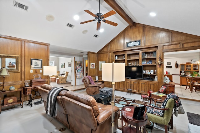 living room with visible vents, wood walls, and beamed ceiling