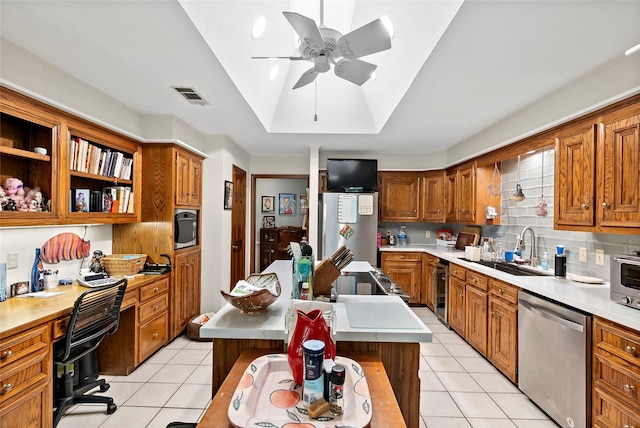 kitchen with a center island, visible vents, stainless steel dishwasher, a sink, and fridge