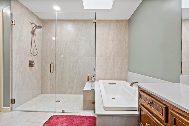 bathroom with a shower stall, vanity, and a bath