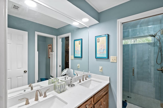 full bathroom featuring a stall shower, a sink, visible vents, and crown molding