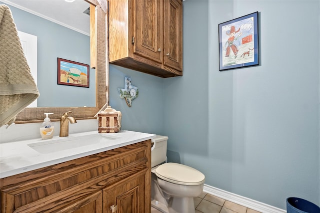 bathroom featuring baseboards, vanity, toilet, and tile patterned floors