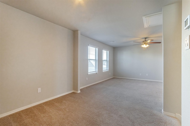 unfurnished room featuring light colored carpet, ceiling fan, and baseboards