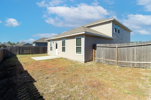 back of property featuring a lawn, a patio area, and a fenced backyard