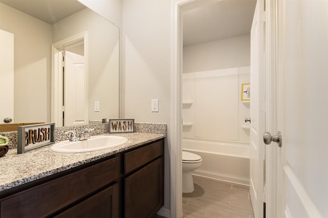 bathroom featuring tub / shower combination, vanity, and toilet