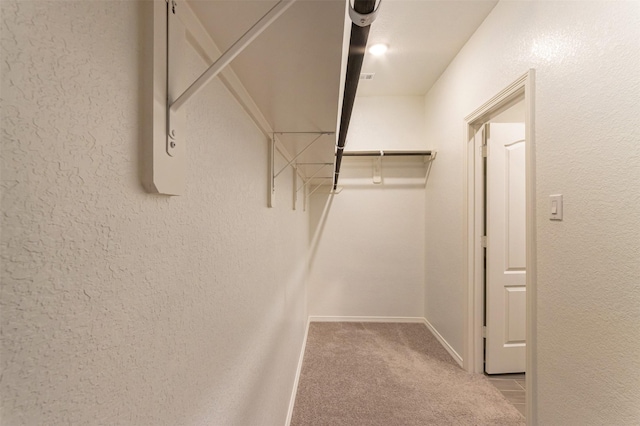 walk in closet featuring carpet