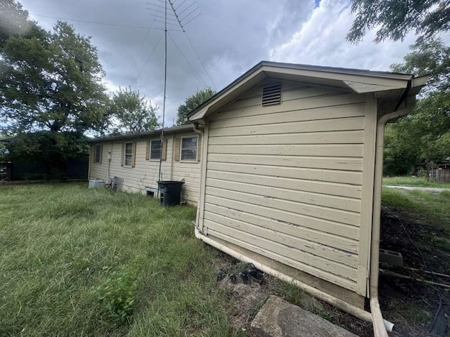 view of side of property with a lawn