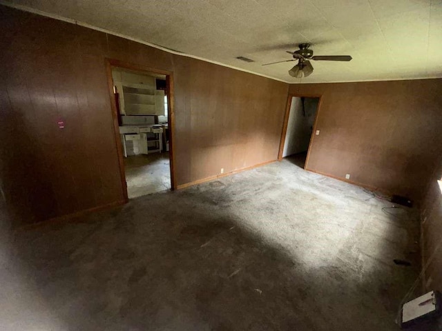 interior space featuring ceiling fan, carpet floors, and visible vents