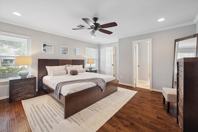 bedroom featuring dark wood-style flooring, multiple windows, visible vents, and baseboards