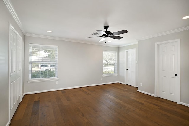 unfurnished bedroom featuring ornamental molding, dark wood-style flooring, visible vents, and baseboards