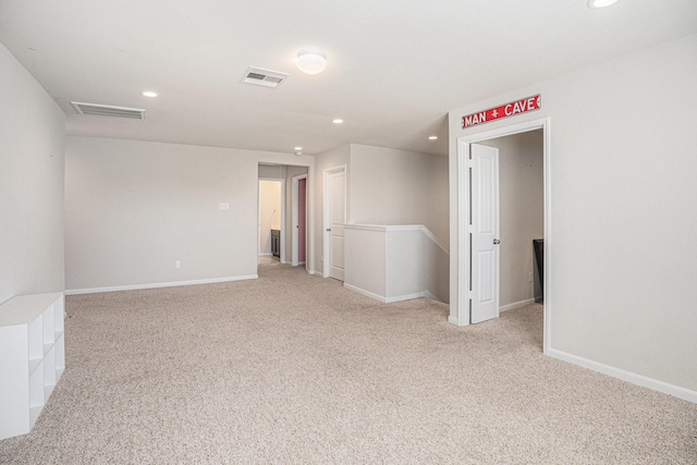 spare room featuring recessed lighting, visible vents, and light colored carpet