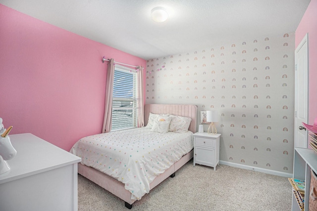 bedroom featuring light colored carpet and baseboards