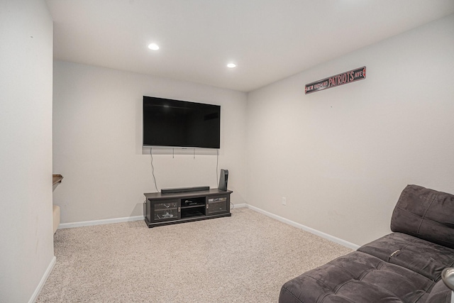 carpeted living room featuring baseboards and recessed lighting