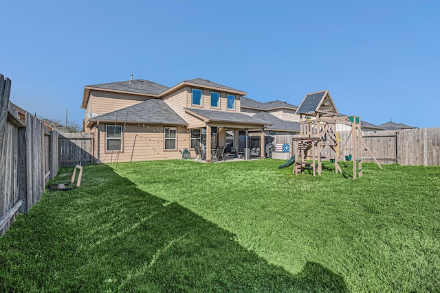 back of property with a patio area, a fenced backyard, a playground, and a yard