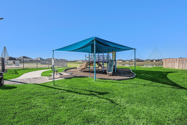 community play area with fence and a lawn