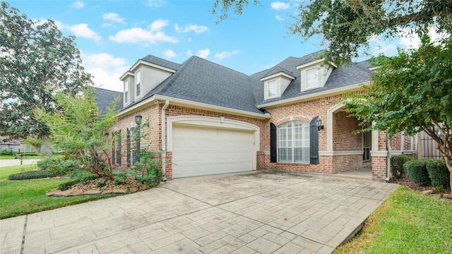 view of front of property with driveway, brick siding, a garage, and roof with shingles