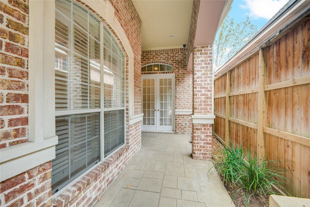 view of patio with french doors and fence