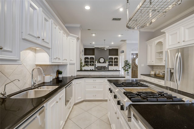 kitchen featuring visible vents, appliances with stainless steel finishes, crown molding, white cabinetry, and a sink