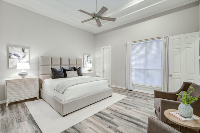 bedroom featuring crown molding, baseboards, and wood finished floors