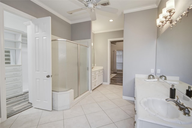 full bath with tile patterned flooring, vanity, ornamental molding, and a shower stall