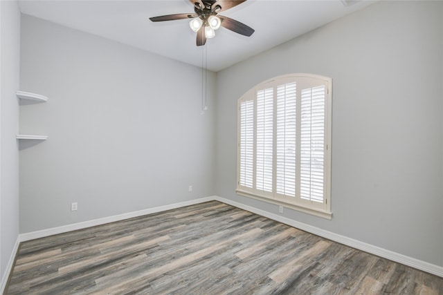 unfurnished room with ceiling fan, baseboards, and wood finished floors