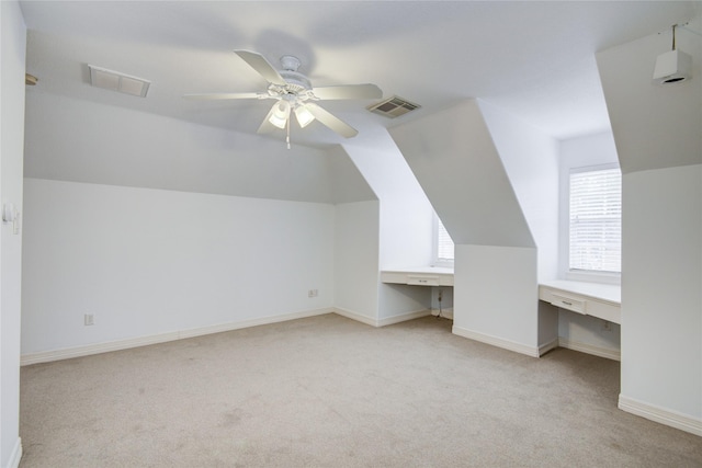 bonus room with carpet, visible vents, baseboards, and built in study area