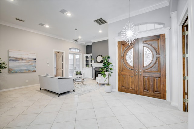 foyer featuring ornamental molding, visible vents, and a notable chandelier