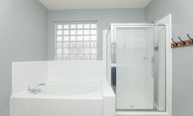 bathroom with a garden tub and a stall shower