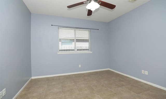 tiled spare room with visible vents, baseboards, and ceiling fan