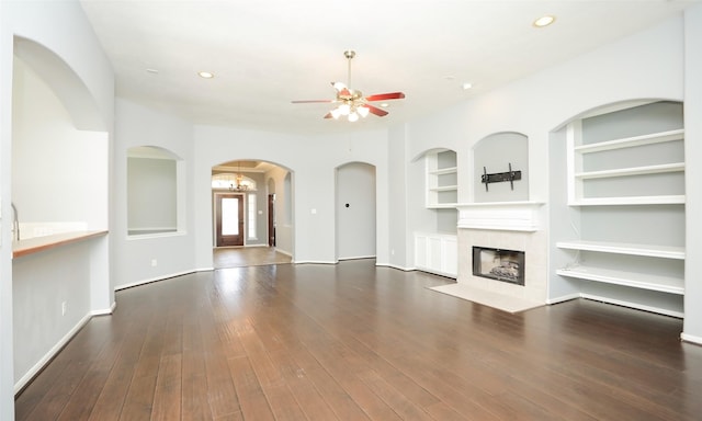 unfurnished living room with built in shelves, ceiling fan, recessed lighting, a fireplace, and hardwood / wood-style flooring