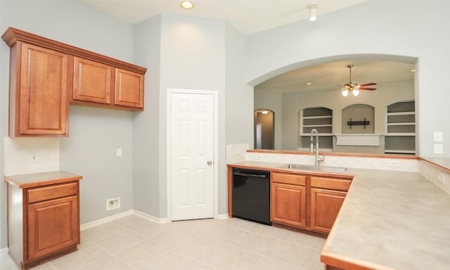 kitchen featuring ceiling fan, dishwasher, light countertops, brown cabinets, and a sink