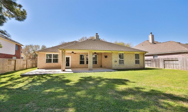 back of house with a fenced backyard, a patio, brick siding, and a ceiling fan