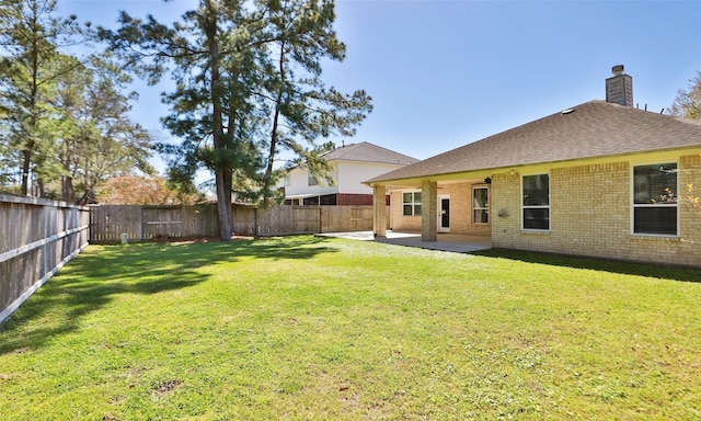 view of yard with a patio and a fenced backyard