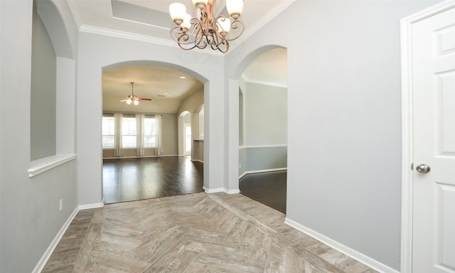 corridor featuring crown molding, baseboards, an inviting chandelier, arched walkways, and parquet floors