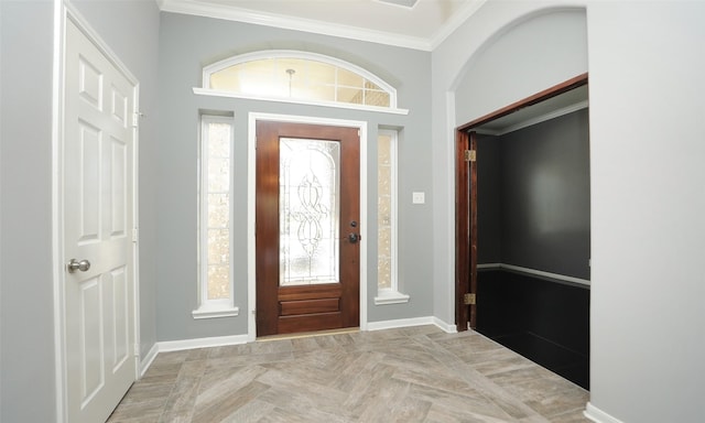 entrance foyer featuring crown molding and baseboards