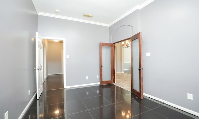 unfurnished bedroom featuring dark tile patterned floors, visible vents, crown molding, and baseboards