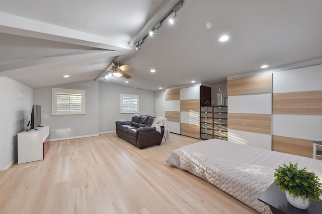 bedroom featuring wood finished floors, baseboards, lofted ceiling with beams, recessed lighting, and track lighting