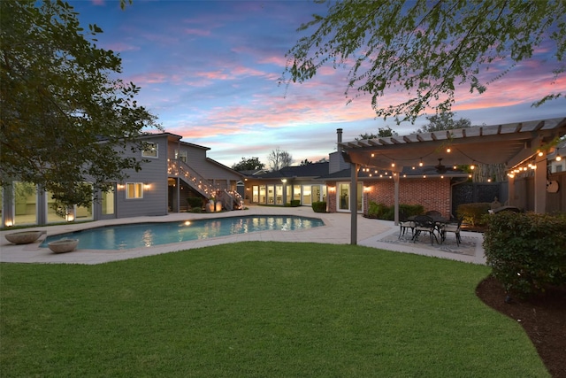 pool at dusk featuring an outdoor pool, a yard, a patio area, and stairway