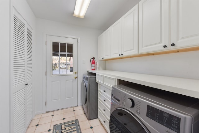 washroom featuring cabinet space and washing machine and dryer