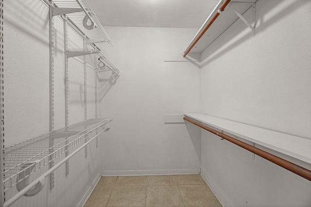 walk in closet featuring light tile patterned floors